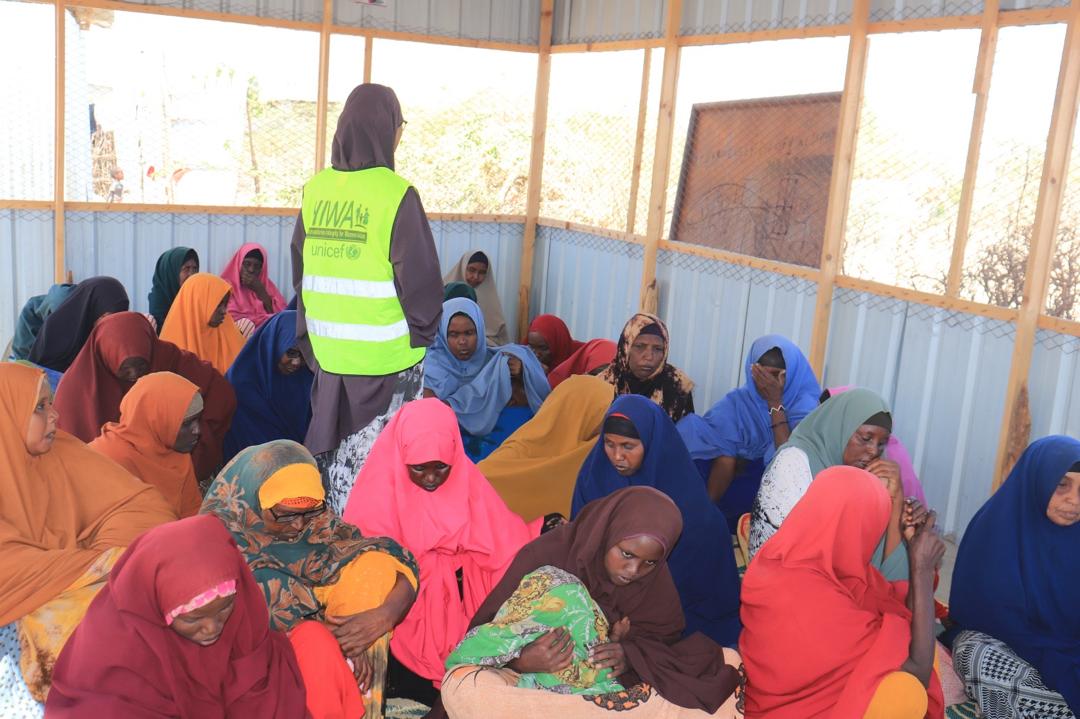 HIWA facilitator in a community discussion with women