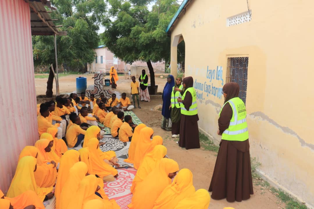 HIWA facilitators speaking with schoolchildren