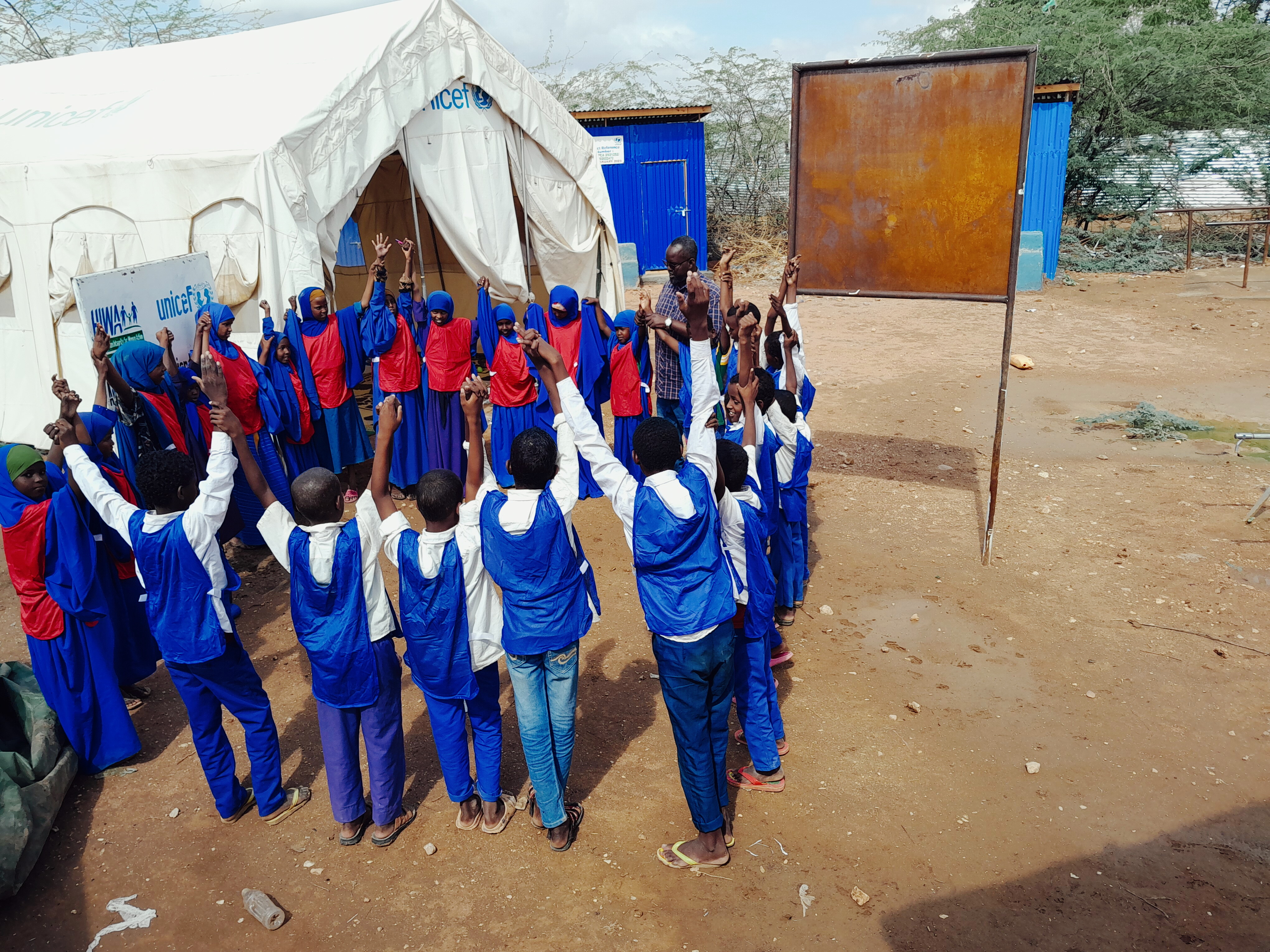 Children taking part in an outdoor group activity with HIWA